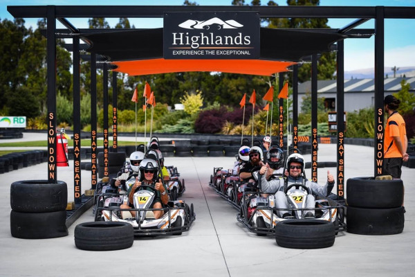 Tourists riding outdoor Go Karts at Highlands Motorsport Park.
