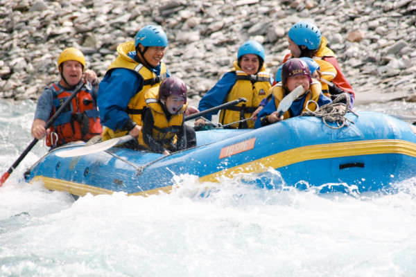 Family enjoying Shotover white water rafting in Queenstown, New Zealand.